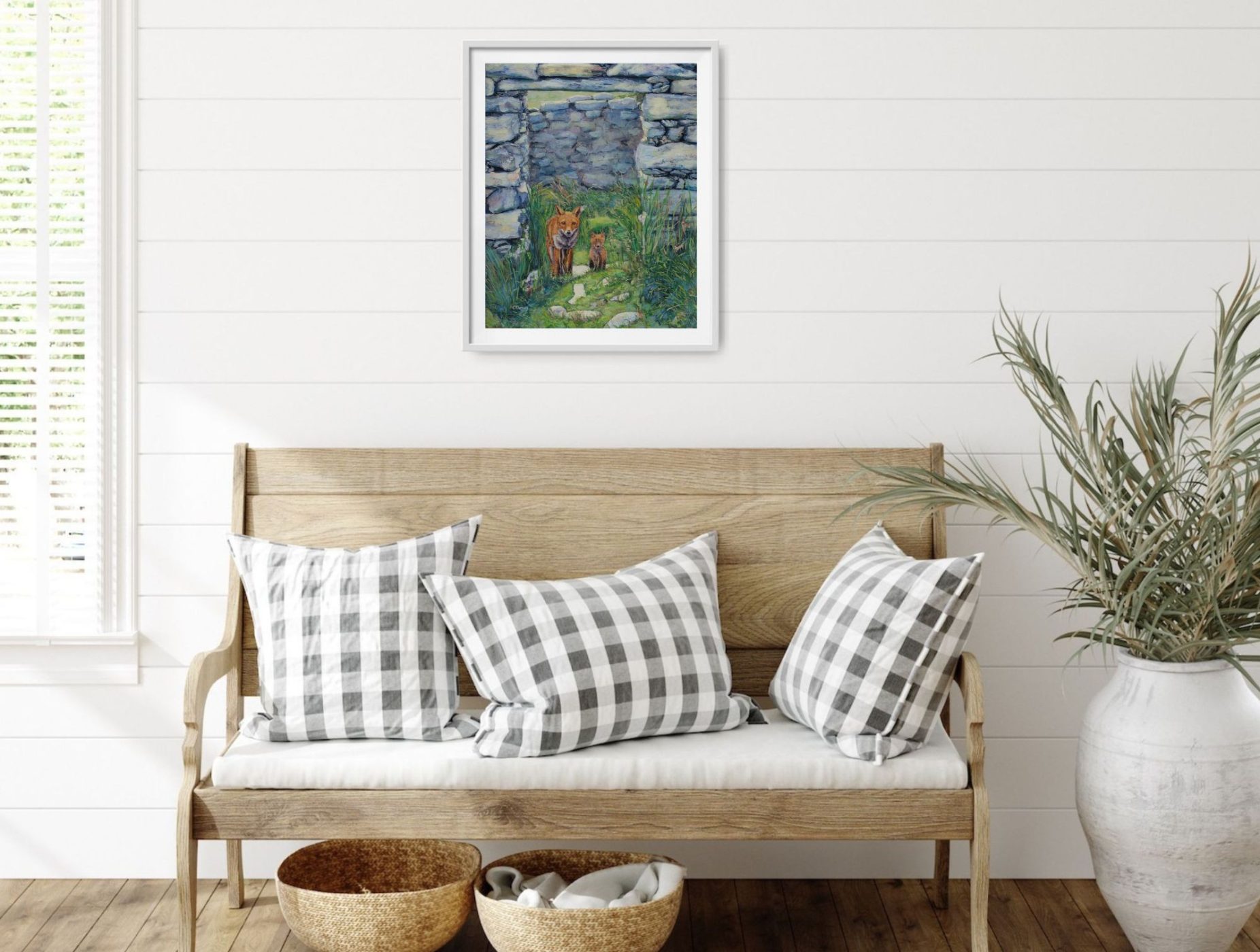 The fox painting displayed above a wooden bench.